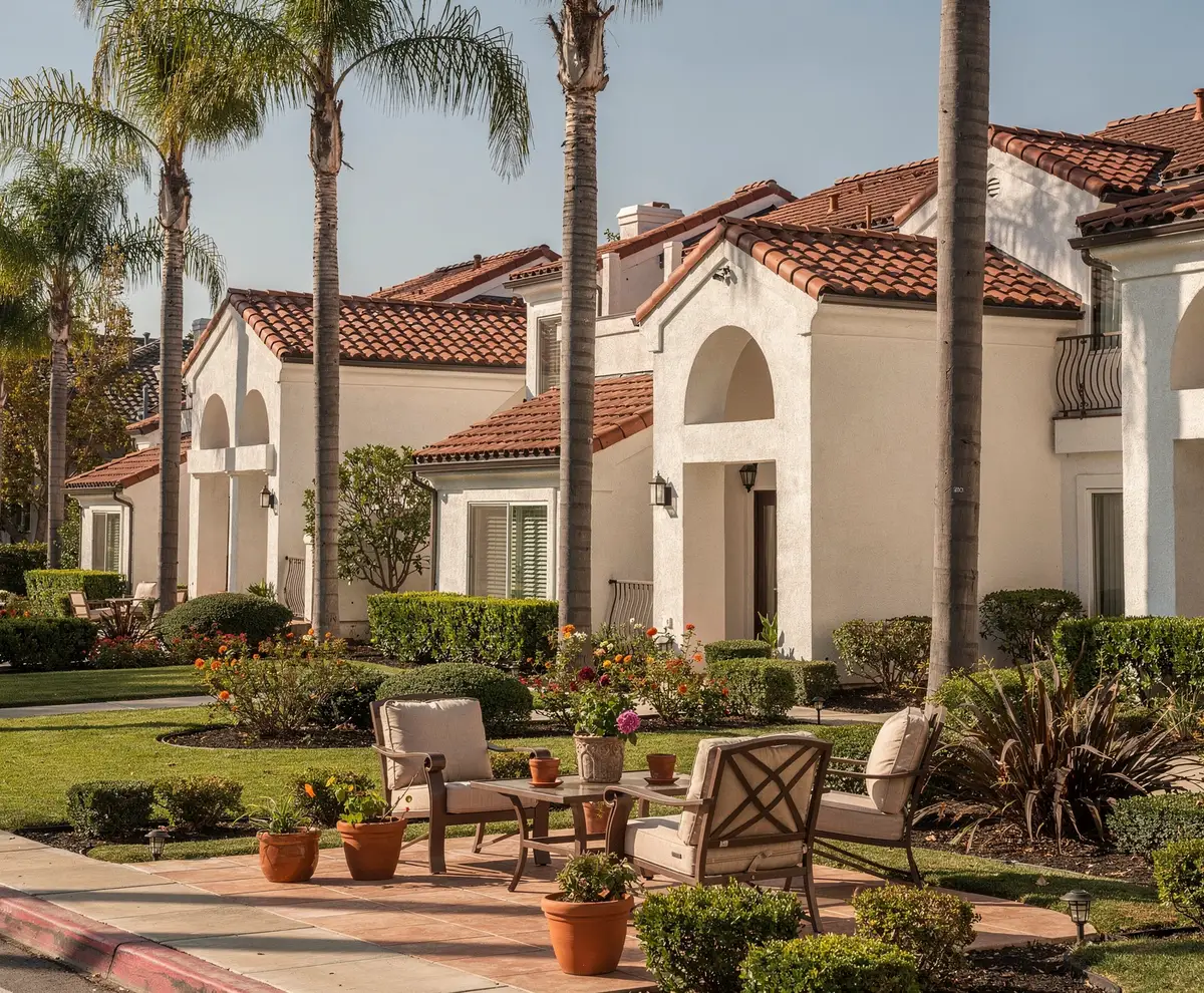 Landscaped Southern California HOA community with palm trees and shared patio seating.